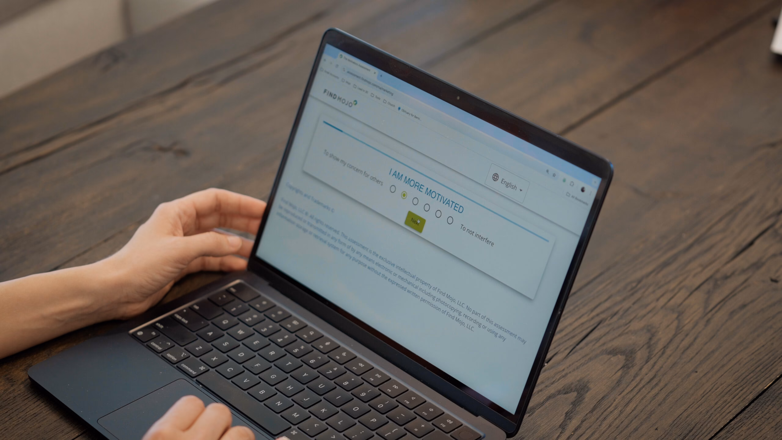 FindMojo Motivators Assessment results displayed on a computer with a hand in view, symbolizing personalized insights, motivation, and career alignment.